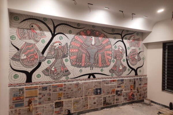 Residential interior featuring handcrafted Madhubani art wall and counter border by Yuvarti Craft Studio, showcasing traditional Indian folk painting style.