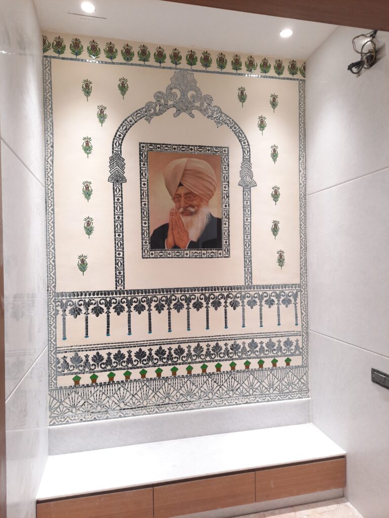 Residential project wall featuring Thikri mirror art combined with hand-painted artwork by Yuvarti Craft Studio, blending traditional craftsmanship with modern interiors